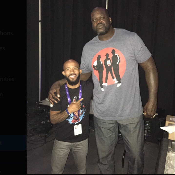 looming over Johnson is NBA legend Shaquille O'Neal, towering at 7 feet 1 inch and weighing 325 pounds.